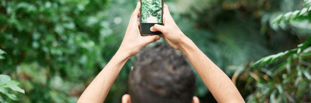 A man taking a picture over his head