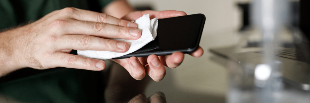 A person cleaning their phone screen